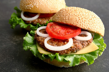 Tasty hamburgers on table