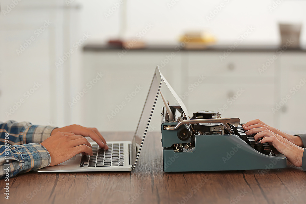 Wall mural Old typewriter and laptop, concept of technology progress