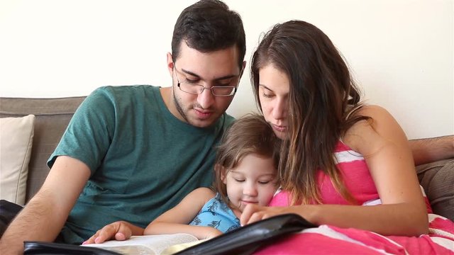 Young family studying the Word of God