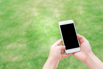Hand holding blank screen mobile smart phone outdoor