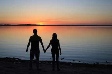 Silhouette of a Couple Walking on the Beach