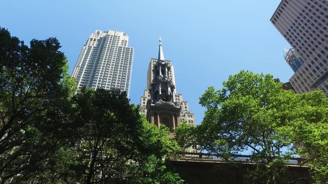 A daytime establishing shot of looking up at the steeple of St. Paul's Chapel of Trinity Church Wall Street in lower Manhattan.  	