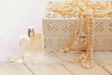 White pearls necklace and perfume bottle