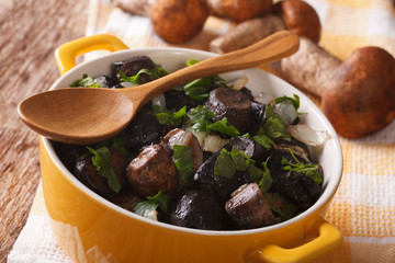 Fried porcini mushrooms and onion closeup. horizontal
