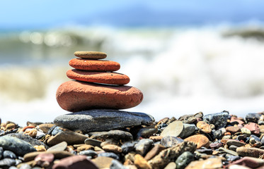Seashore with stone construction on blue sky background
