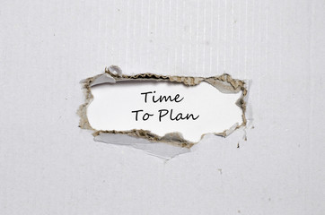The words time to plan appearing behind torn paper