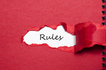 The word rules appearing behind torn paper