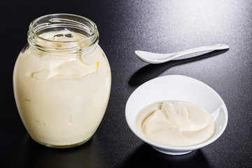 Sour Cream in a glass jar and in white plate