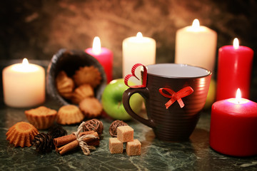 night cup of tea with candle and apple