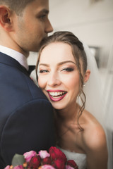 Portrait of happy newly wedding couple with bouquet
