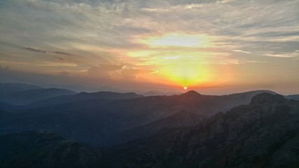 Dramatic cloudscape and beautiful sunset over the mountain hills