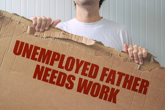 Unemployed father needs work, man holding banner