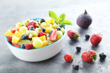 Fresh fruit salad on a grey wooden table
