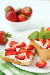 French toasts with cream cheese and strawberry on wooden table