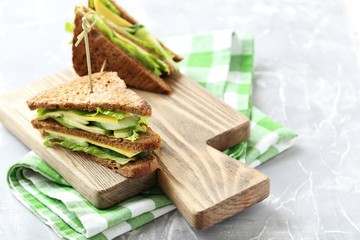 Tasty and fresh sandwiches on a grey table