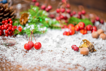 Fototapeta na wymiar beautiful Christmas background of apple, nuts, cones, berries, f