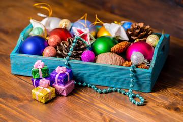 vintage wooden box with Christmas decoration, tinsel,  pinecones