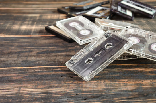 Old audio cassettes on wooden background. music abstract.