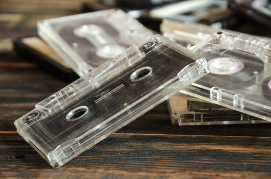 Old audio cassettes on wooden background. music abstract.