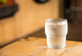 Glass water on wooden table.