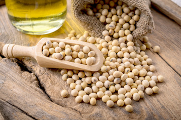 closeup is some soybeans with wooden spoon
