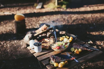 Foto op Plexiglas Dinner on the nature of the fire. Fish with potatoes and salad © stock.film