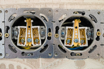 Open electric socket strip without front panel. Close-up. Work on installing interlocked electrical outlets.