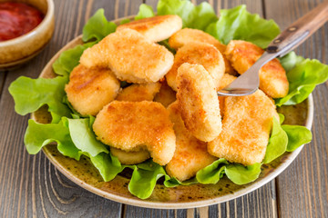 Chicken nuggets with ketchup.