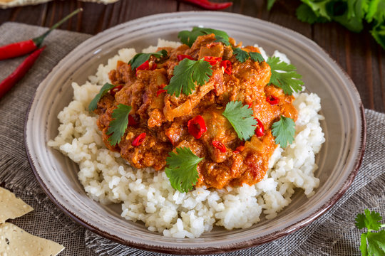 Chicken curry with rice and cilantro.