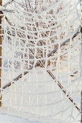Winter background. The grid of white frost.