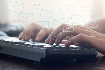 hand typing on keyboard to send electronic mail message