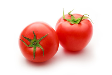 Two fresh tomatoes on white background