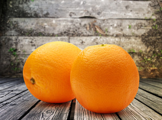 Two fresh oranges on wooden background