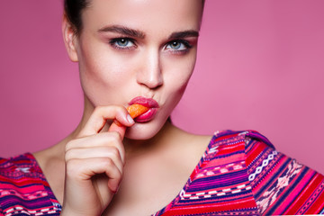 sexy girl eating a carrot. concept of healthy nutrition and sexu