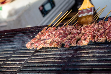 Brushing Sauce on Beef Skewers
