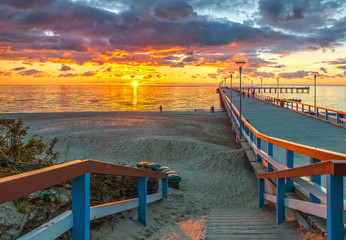 Colorful sunset at a famous marine pier in the Baltic resort city of Palanga, Lithuania, Europe - obrazy, fototapety, plakaty