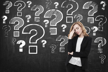 Stressed woman near chalkboard