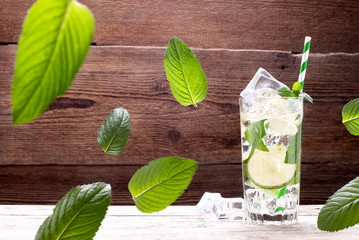 Cocktail with mint and ice on old boards