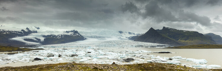 old big glacier under clouds