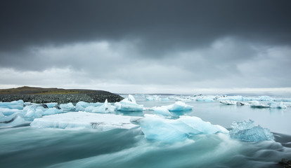 icebergs in water with strong current in lagoon