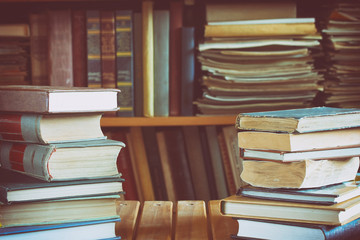 two piles of books on wooden table