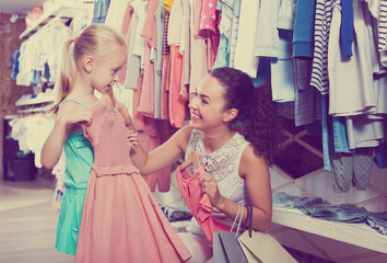 Mother with daughter buying clothes