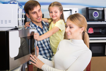 Portrait of family selecting microwave