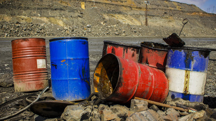 Empty metal barrels in the iron quarry