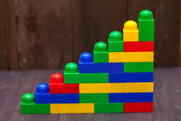 construction toy parts assembled in a pile on a wooden floor