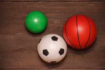 three children's ball on a wooden background