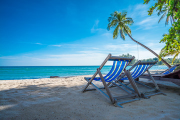 Beautiful tropical island beach with chairs - Travel summer vacation concept.