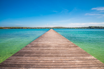Obraz premium Long wood bridge on beautiful tropical island beach summer holiday - Travel summer vacation concept