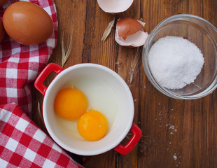 Raw eggs in red and white bowl