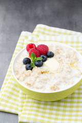 Oatmeal porridge in bowl with berries raspberries and blackberri